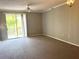 Spacious living room with sliding glass doors leading to balcony at 5701 Bentgrass Dr # 18-203, Sarasota, FL 34235