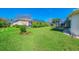 Expansive backyard featuring lush green lawn, screened-in lanai, and a charming gazebo for outdoor enjoyment at 5872 Mckinley Rd, Venice, FL 34293