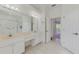 Well lit bathroom features a double sink vanity and a view into the primary bedroom at 5872 Mckinley Rd, Venice, FL 34293