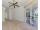 This bedroom offers neutral carpet, a ceiling fan, and sliding glass doors to the outside patio at 5872 Mckinley Rd, Venice, FL 34293