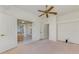 Bedroom features ceiling fan, walk-in closet and a doorway that leads to a patio at 5872 Mckinley Rd, Venice, FL 34293