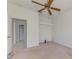 Bedroom with ceiling fan and an open doorway to the bathroom at 5872 Mckinley Rd, Venice, FL 34293