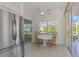 Charming breakfast nook adjacent to the kitchen with stainless steel refrigerator at 5872 Mckinley Rd, Venice, FL 34293