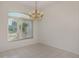 Light filled dining room with elegant chandelier and a large arched window at 5872 Mckinley Rd, Venice, FL 34293