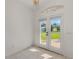 Bright entryway with tile floors and glass double doors offers a view of the well-maintained front yard at 5872 Mckinley Rd, Venice, FL 34293