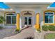 Inviting front entrance showcasing double doors framed by decorative pillars and well-maintained landscaping at 5872 Mckinley Rd, Venice, FL 34293