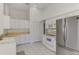 Spacious kitchen features white cabinets, appliances, and tile flooring at 5872 Mckinley Rd, Venice, FL 34293