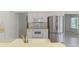 Bright kitchen featuring white cabinets, and stainless steel refrigerator and appliances at 5872 Mckinley Rd, Venice, FL 34293