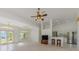 Bright living room features a ceiling fan, breakfast bar and stainless steel refrigerator at 5872 Mckinley Rd, Venice, FL 34293