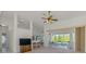 Bright living room area with tile and carpet flooring, with access to the outdoor patio area at 5872 Mckinley Rd, Venice, FL 34293