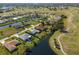 Scenic aerial view of a waterfront property with stunning golf course views and mature trees at 6 Bunker Cir, Rotonda West, FL 33947