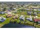 Aerial panorama featuring waterfront homes with pools and a golf course in a deed restricted community at 6 Bunker Cir, Rotonda West, FL 33947