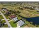 An aerial view showcasing the property's location near a golf course, pond, and lush greenery at 6 Bunker Cir, Rotonda West, FL 33947
