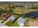 Expansive aerial view of a golf course community with lush greenery and well-maintained homes at 6 Bunker Cir, Rotonda West, FL 33947