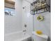 This renovated bathroom features a tub, shower, and a tiled wall with decor at 6 Bunker Cir, Rotonda West, FL 33947