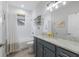 Updated bathroom with a white subway tile shower, granite counters, and a framed mirror at 6 Bunker Cir, Rotonda West, FL 33947