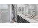 This bathroom has dual sinks, granite counters, and updated tile at 6 Bunker Cir, Rotonda West, FL 33947