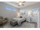 This bedroom has a ceiling fan, neutral paint, and a cozy chair to relax in at 6 Bunker Cir, Rotonda West, FL 33947