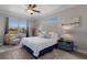 This primary bedroom has wood floors, coastal-themed decor, and plenty of natural light at 6 Bunker Cir, Rotonda West, FL 33947