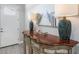 Inviting foyer featuring stylish console table with lamps and a beachy art piece at 6 Bunker Cir, Rotonda West, FL 33947