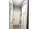 Hallway featuring a white sliding barn door and neutral paint at 6 Bunker Cir, Rotonda West, FL 33947