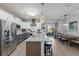 Modern kitchen with granite countertops, stainless steel appliances, and a large island with seating at 6 Bunker Cir, Rotonda West, FL 33947