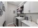 Functional laundry room with modern appliances, ample storage, and a convenient sink at 6 Bunker Cir, Rotonda West, FL 33947