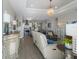 An open-concept living space with modern decor, natural light, and wood-look tile flooring at 6 Bunker Cir, Rotonda West, FL 33947