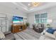 Cozy living room with a large screen TV, wood cabinet, comfortable chair, and neutral rug at 6 Bunker Cir, Rotonda West, FL 33947