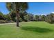 Lush green park area with walking path and bench seating at 6 Bunker Cir, Rotonda West, FL 33947