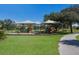 Inviting playground with covered play structures, swings, and slides amidst well-maintained green surroundings at 6 Bunker Cir, Rotonda West, FL 33947