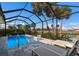 Enjoy a refreshing screened in pool with outdoor loungers and tranquil golf course views at 6 Bunker Cir, Rotonda West, FL 33947