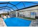 Lovely screened in pool with bar area, poolside seating, and putting green at 6 Bunker Cir, Rotonda West, FL 33947