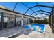 Beautiful screened in pool with poolside seating, bar, and view to interior at 6 Bunker Cir, Rotonda West, FL 33947