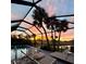 Stunning sunset view from the screened-in pool area, showcasing serene outdoor living at its finest at 6 Bunker Cir, Rotonda West, FL 33947