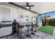 Poolside bar with grill, refrigerator, tv, and putting green at 6 Bunker Cir, Rotonda West, FL 33947