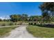 Scenic street view with lush green surroundings, native plantings, and a glimpse of neighborhood at 6 Bunker Cir, Rotonda West, FL 33947