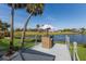 Scenic water view from outdoor patio with table, chairs, and umbrella at 6 Bunker Cir, Rotonda West, FL 33947