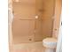 Clean bathroom featuring a glass-enclosed shower and toilet with safety grab bars at 6042 Red Maple Rd # 1001, Bradenton, FL 34210