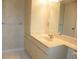 Spacious bathroom vanity with storage, large mirror, and tile flooring at 6042 Red Maple Rd # 1001, Bradenton, FL 34210