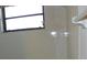 Well lit bathroom featuring white tiles and a window for natural light at 6042 Red Maple Rd # 1001, Bradenton, FL 34210