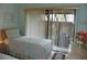 Well-lit bedroom with comfortable twin beds, a dresser, and outdoor views at 6042 Red Maple Rd # 1001, Bradenton, FL 34210