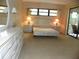 Bright bedroom featuring neutral tones, a large dresser, and sliding glass door to the outside at 6042 Red Maple Rd # 1001, Bradenton, FL 34210