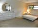 Bedroom with a large dresser, mirror, and two side tables at 6042 Red Maple Rd # 1001, Bradenton, FL 34210