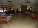 Spacious common room with tile flooring, multiple ceiling fans, bar area, and ample seating at 6042 Red Maple Rd # 1001, Bradenton, FL 34210
