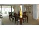 Elegant dining room with wood table, chairs, and a view to a sunroom at 6042 Red Maple Rd # 1001, Bradenton, FL 34210