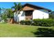 A clean and modern condo exterior with manicured landscaping and a healthy lawn at 6042 Red Maple Rd # 1001, Bradenton, FL 34210