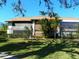 Bright exterior view of a condo with a screened-in patio and well-kept lawn at 6042 Red Maple Rd # 1001, Bradenton, FL 34210