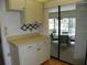 Efficient kitchen with bright countertops that offer an airy view into the sunroom at 6042 Red Maple Rd # 1001, Bradenton, FL 34210