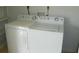 Bright laundry room featuring a white side-by-side washer and dryer set at 6042 Red Maple Rd # 1001, Bradenton, FL 34210